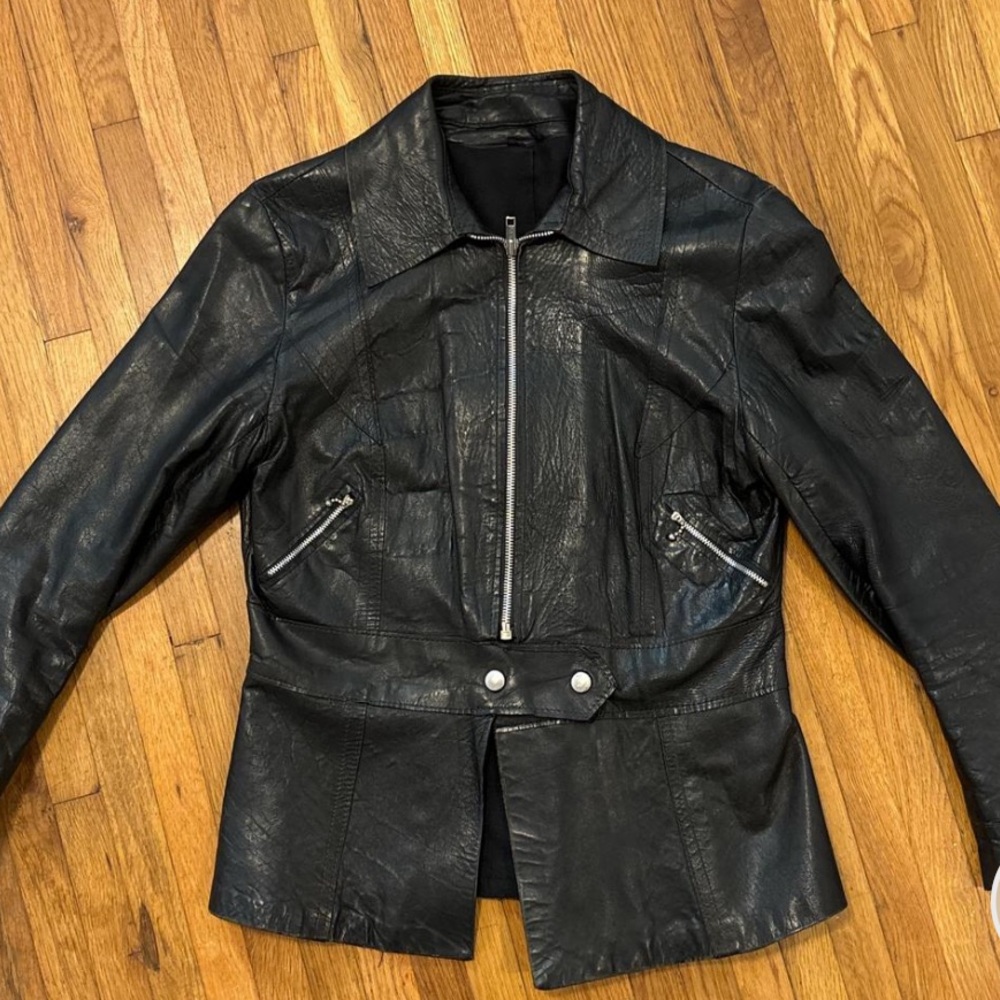 Beautiful worn in black leather jacket with silver hardware.